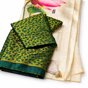 Ivory Banarasi saree with a bottle green Blouse